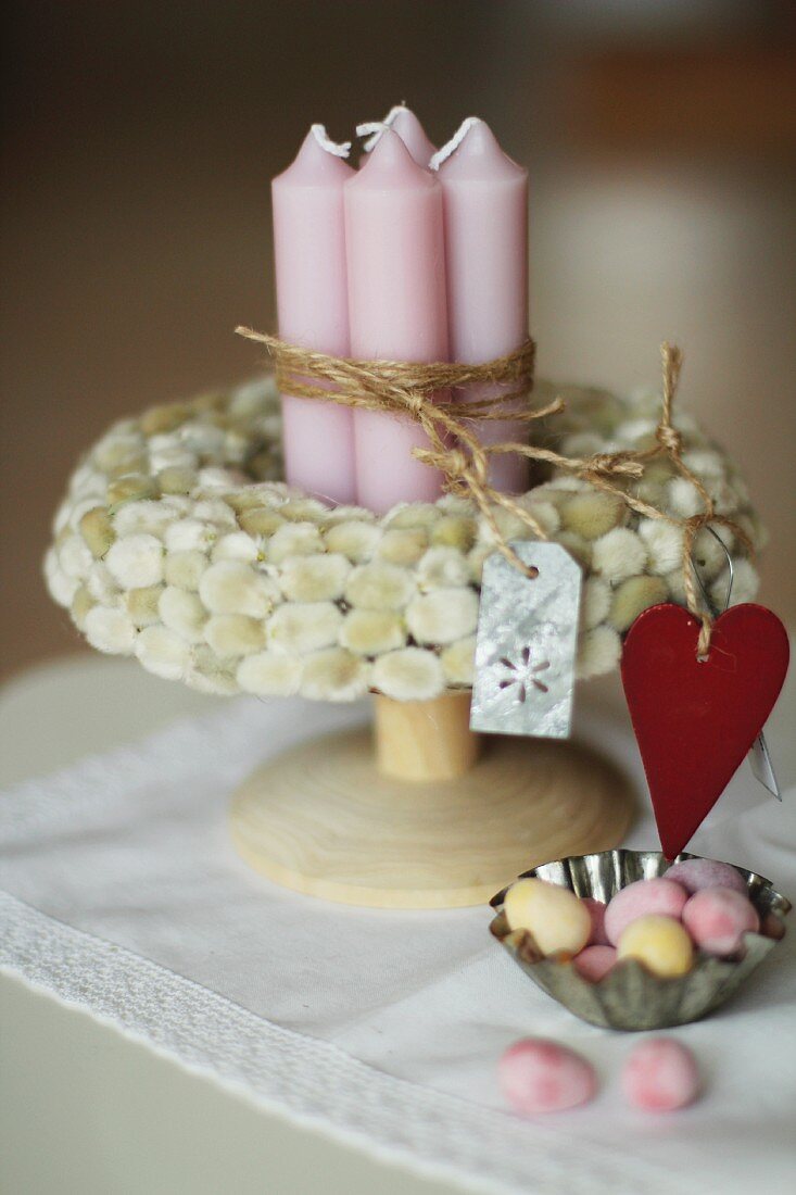 Bundle of candles in a willow wreath and Easter eggs