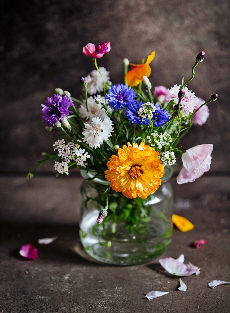 Posy of wild flowers in drinking glass