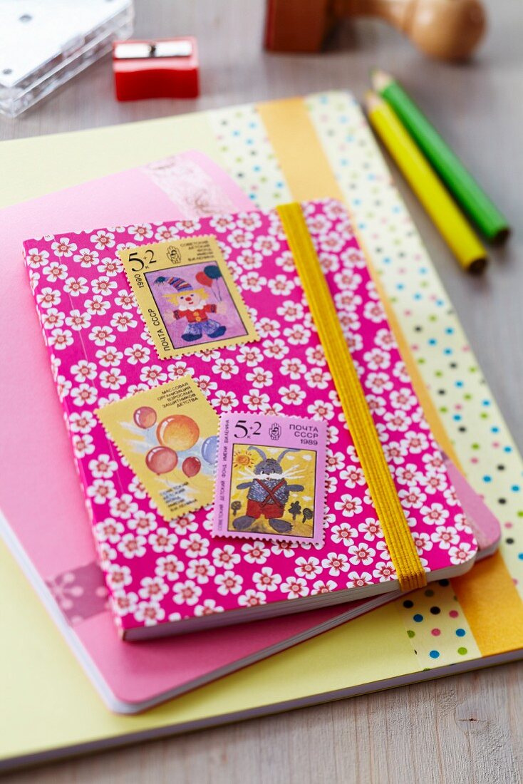 Notebook decorated with postage stamps