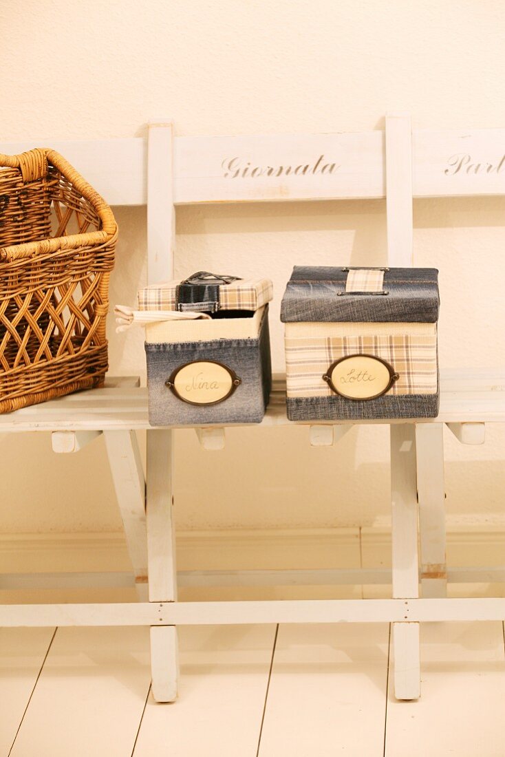 Boxes with hand-sewn, denim covers on vintage garden bench
