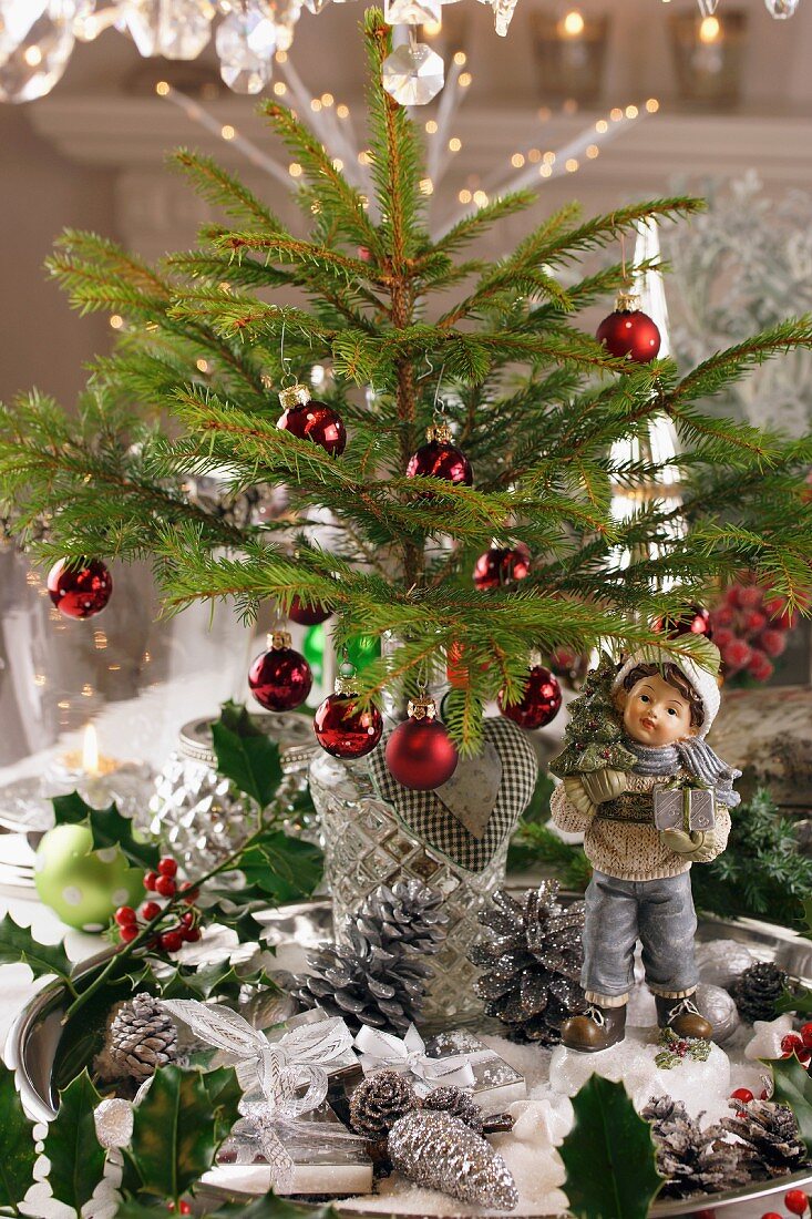Ein weihnachtlich dekorierter Tisch mit Mini-Weihnachtsbaum und Figur