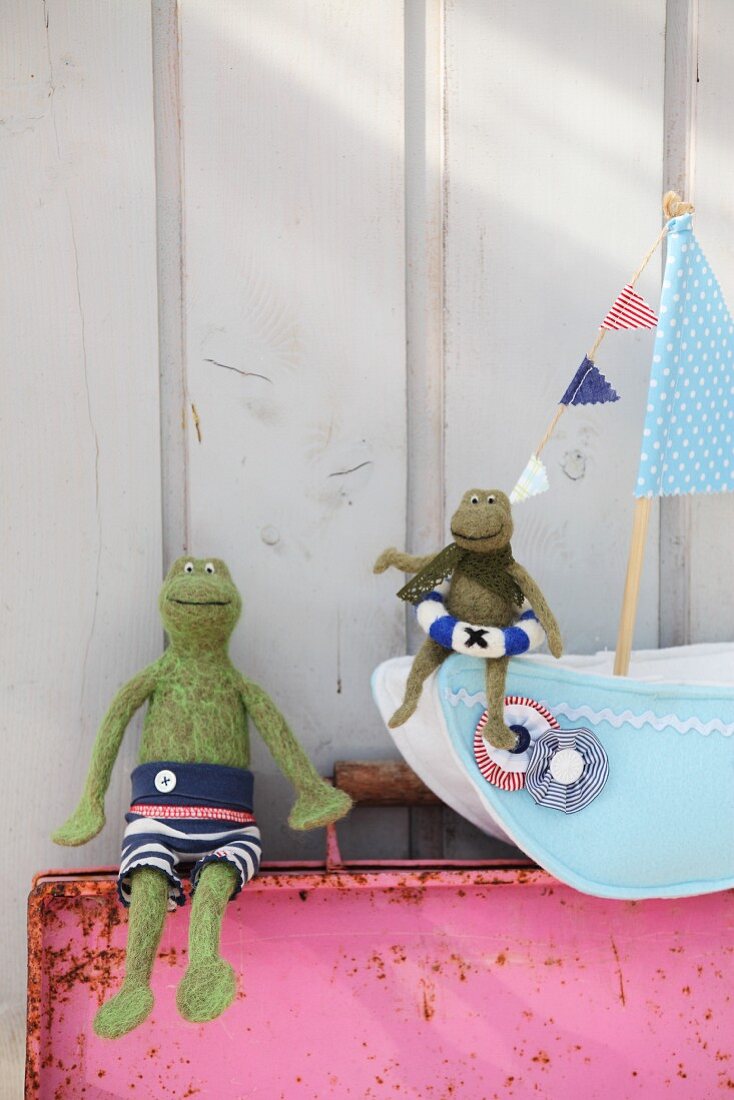 Green felt frogs and hand-crafted felt boat
