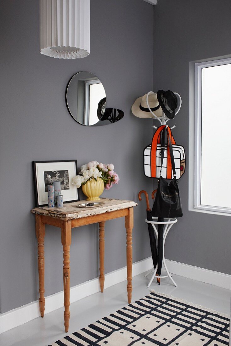 Cloakroom in cool black, white and grey colour scheme relieved by vintage-effect console table