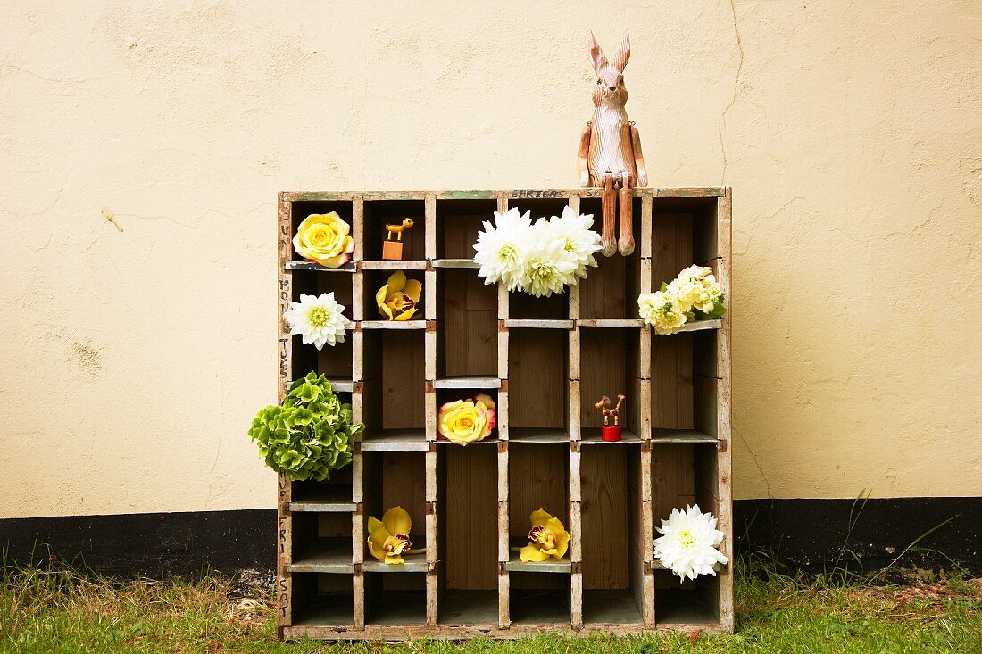 Large display case with cut flowers and hare figurine