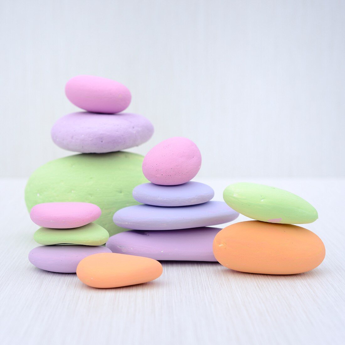 Stacked pebbles painted in pastel colours