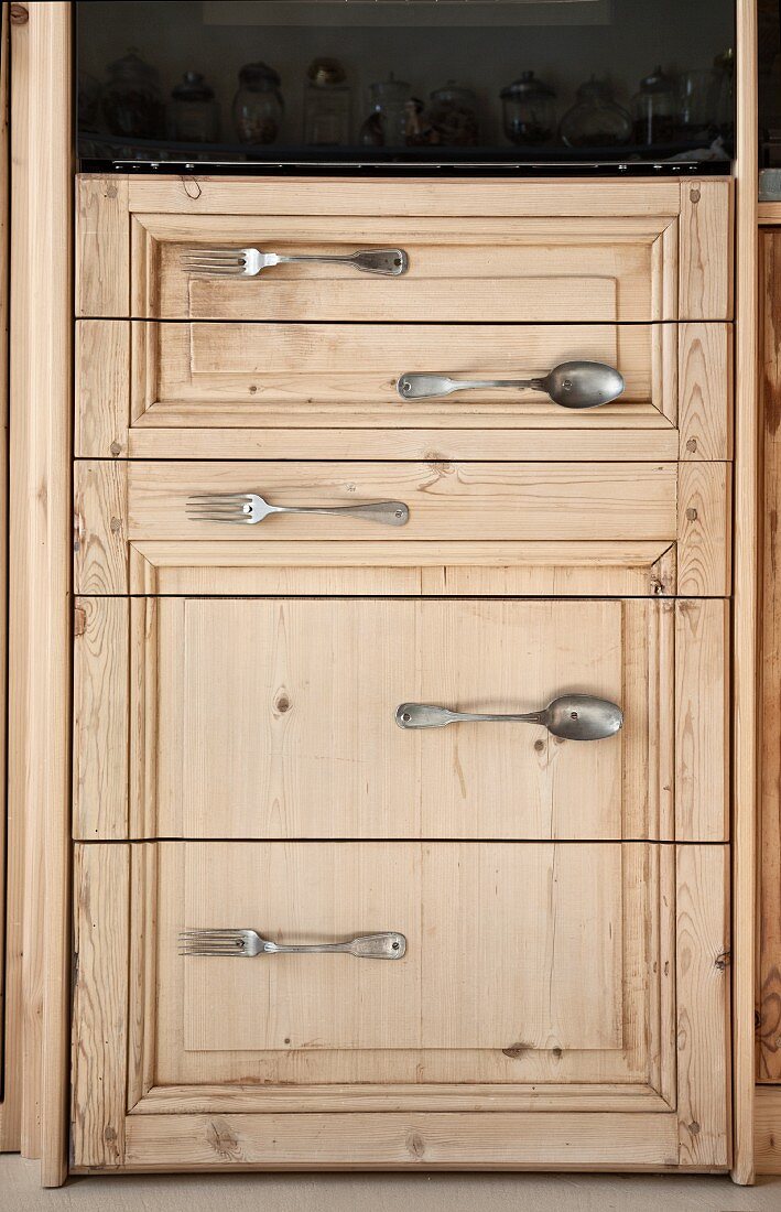 Cupboard door with handles made from vintage cutlery
