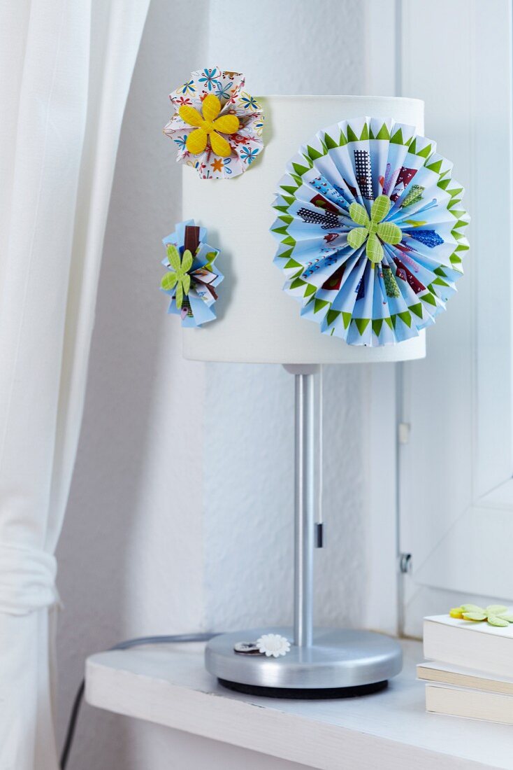 Colourful paper flowers decorating lampshade