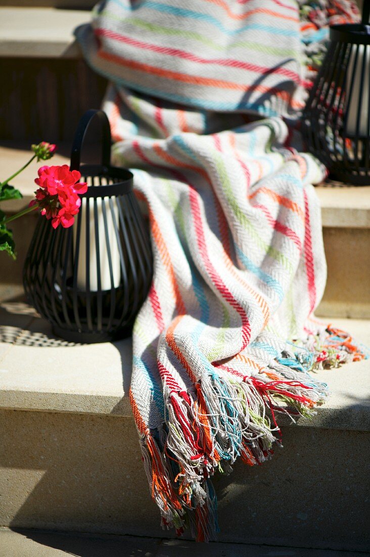 Candle lanterns & blanket on steps