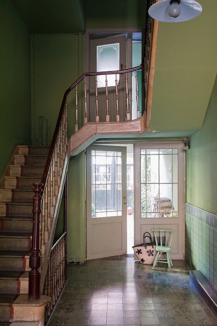 Stairwell with green walls & staircase with old wooden balustrade