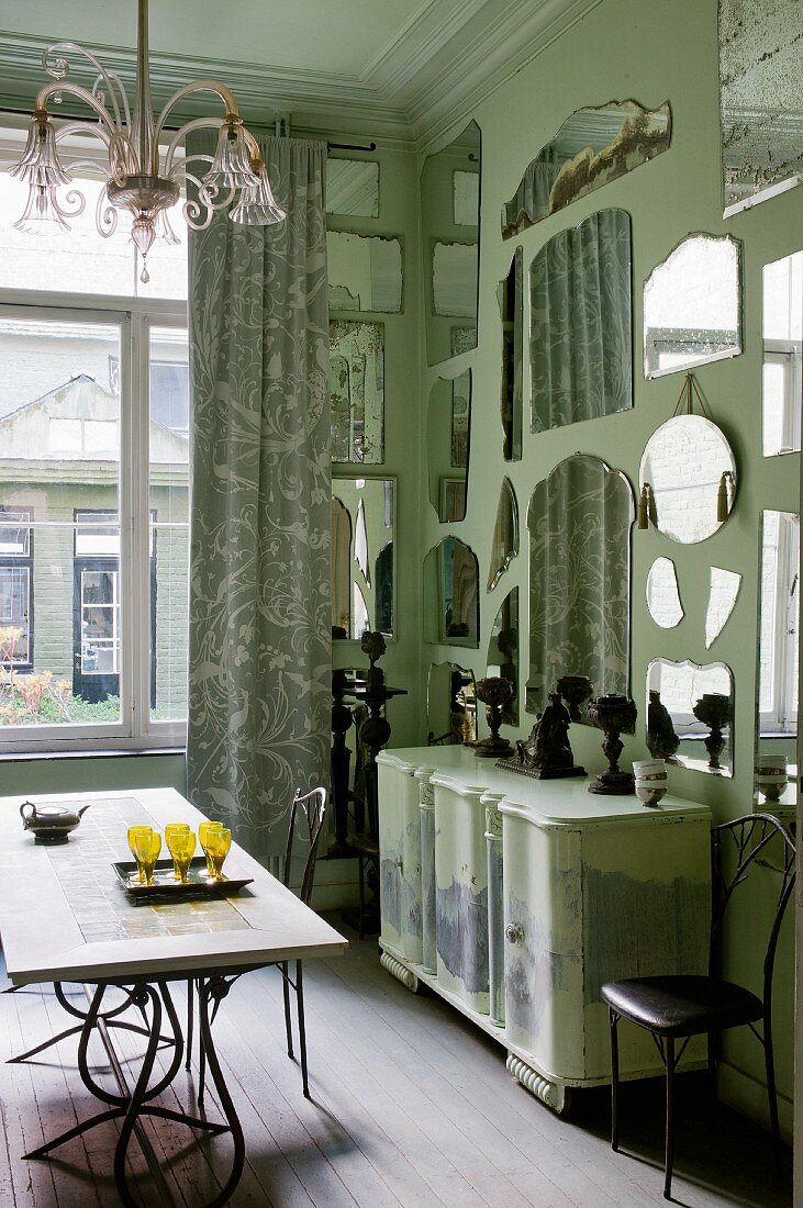 Mint green interior with unusual, floor-to-ceiling collection of mirrors