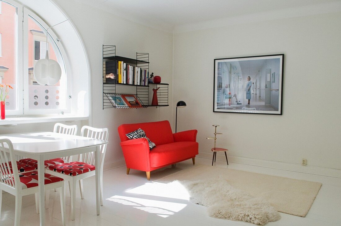 Modernes Wohnbereich mit Esstisch und rotem Sofa