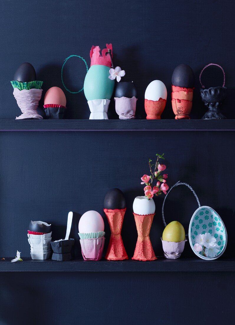 Eggs in decorative egg cups on shelves