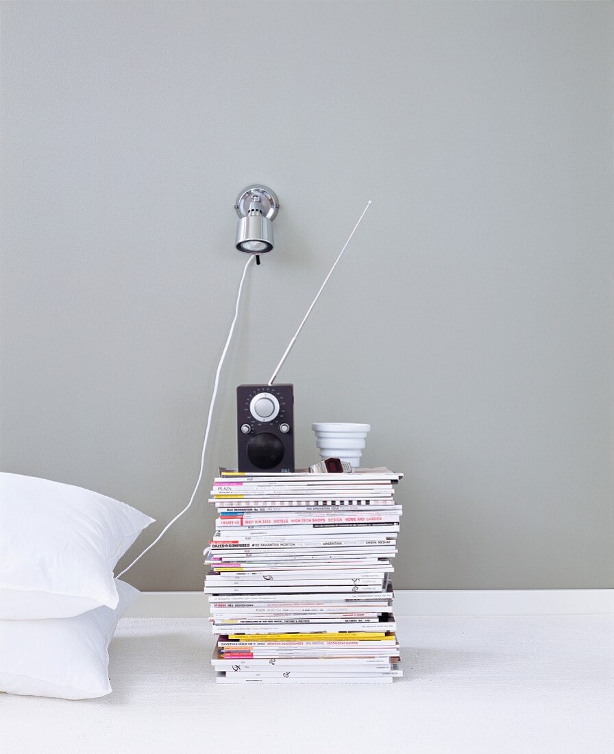 A bedside table made of magazines