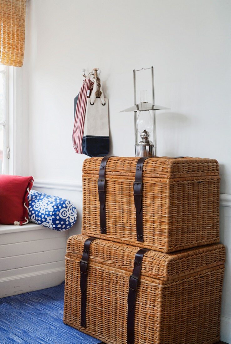 Two wicker trunks in interior with maritime decor