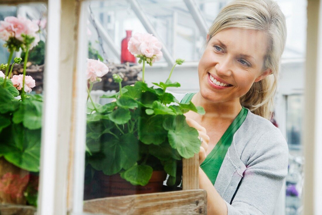 A blond woman working in a flower shop, Sweden