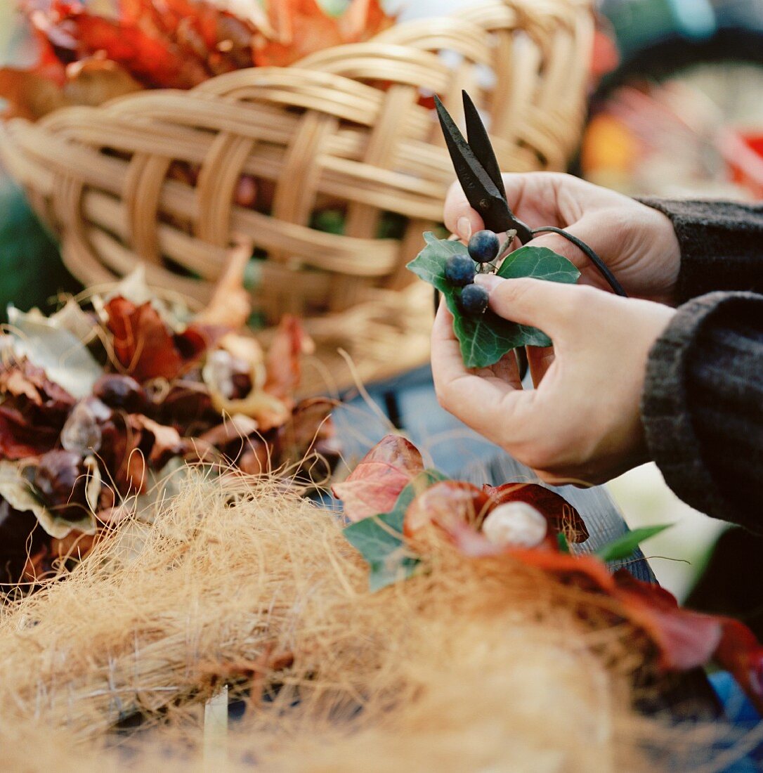 Hand-tying a decorative, autumnal wreath