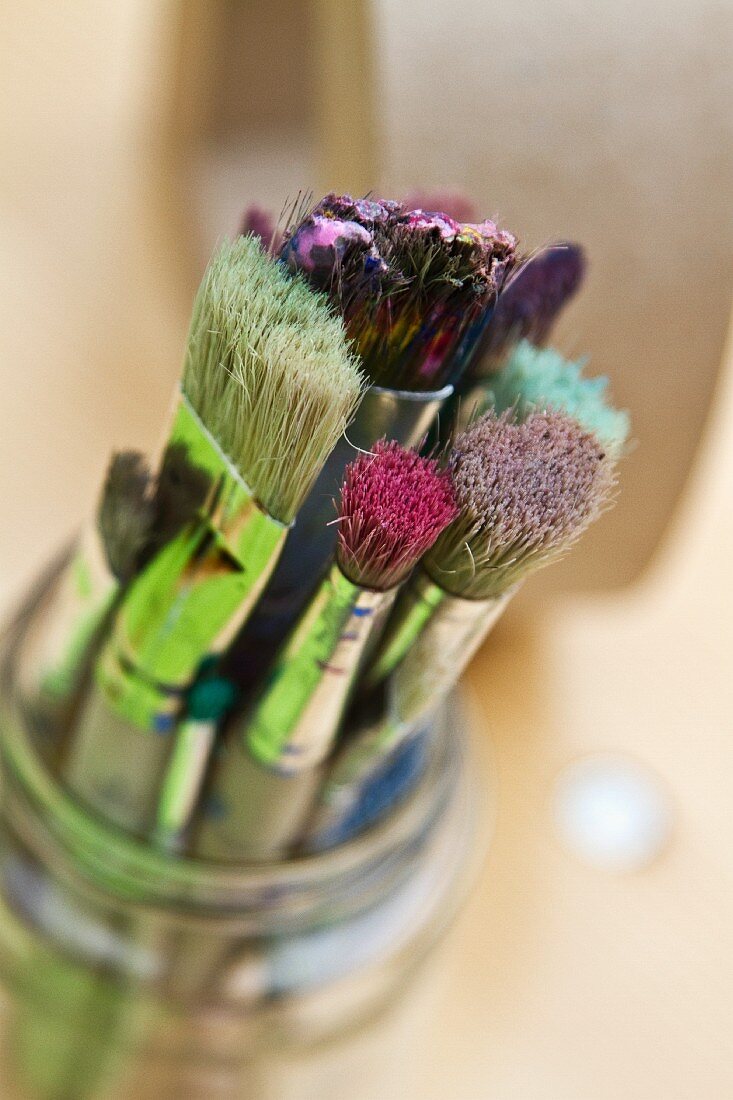 Used paintbrushes in glass jar
