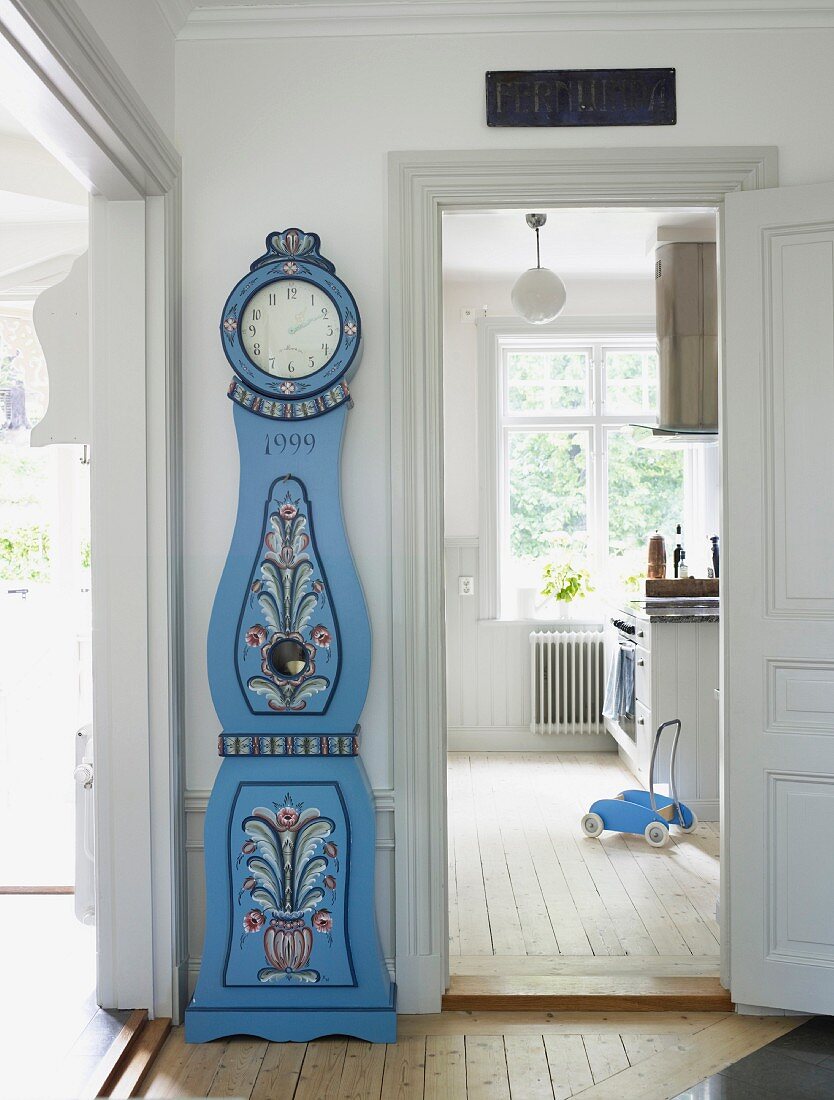 View into kitchen from hallway with hand-painted blue grandfather clock