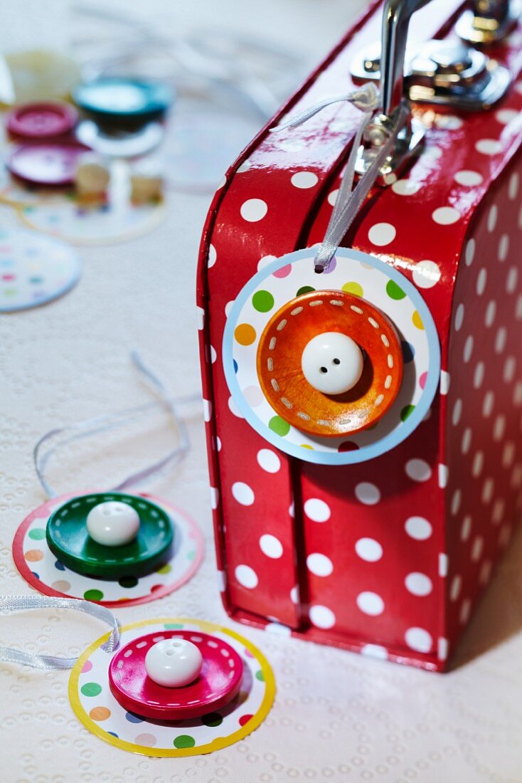 Suitcase tag decorated with buttons