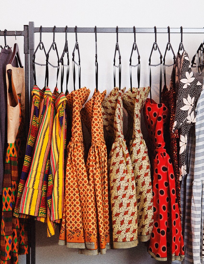 Colourful collection of dresses on clothes rack