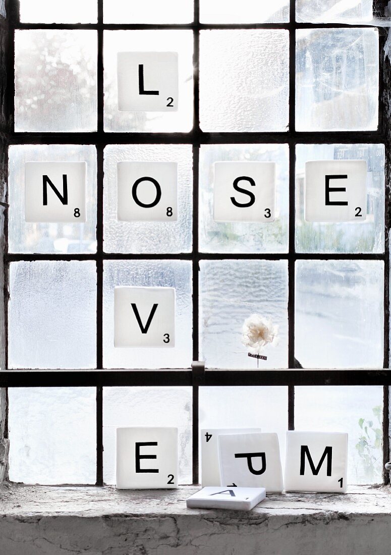 Scrabble letters: white foam squares with black letters decorating window