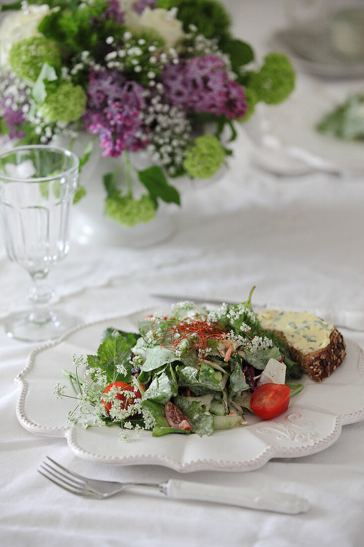 Salad on white plate with scalloped edge