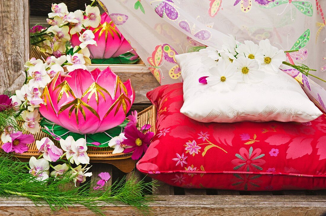 Waterlily shaped paper Chinese lantern with Orchids and cushions outside