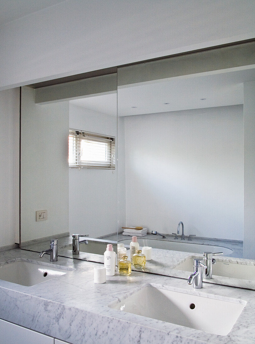 Modern bathroom with double washbasin and large mirror