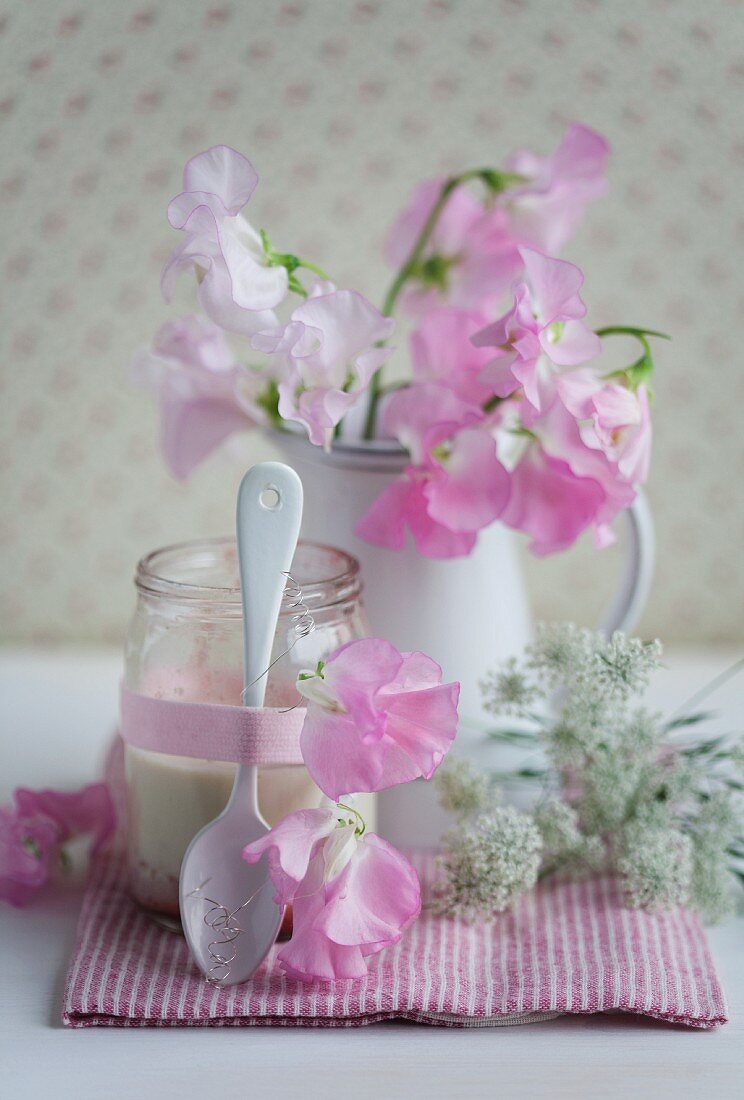 Jar of strawberry yoghurt decorated with sweet peas & chervil flowers