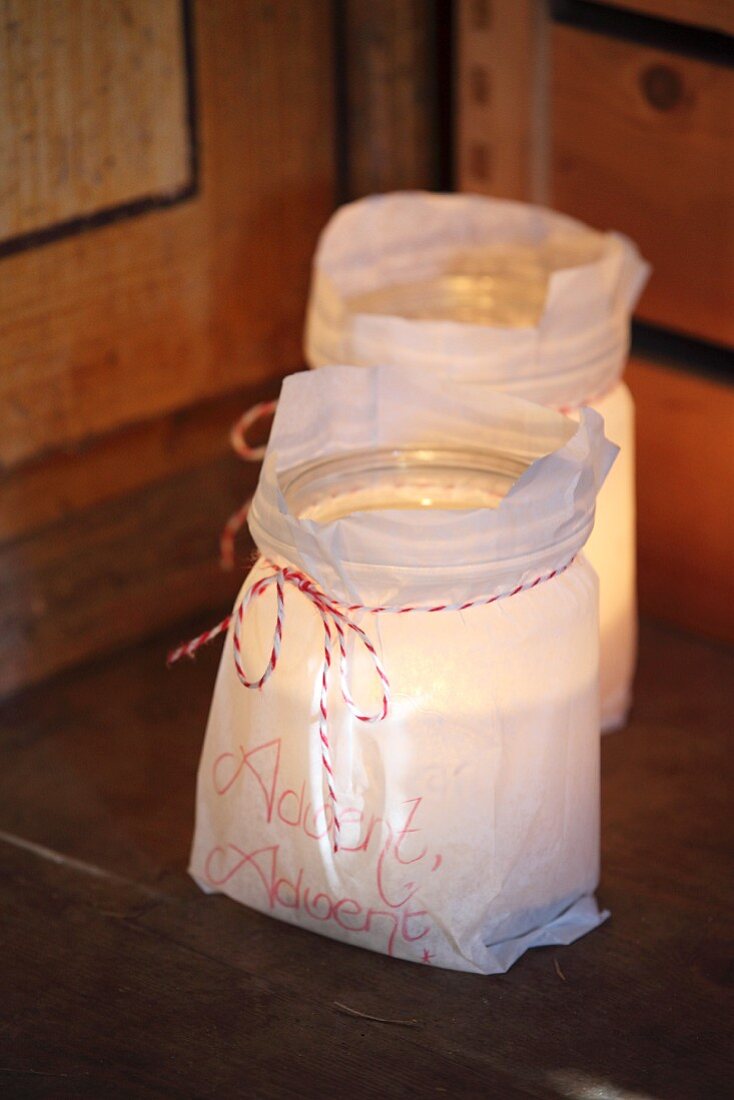 Candle lanterns made from mason jars and paper bags with hand-written mottos