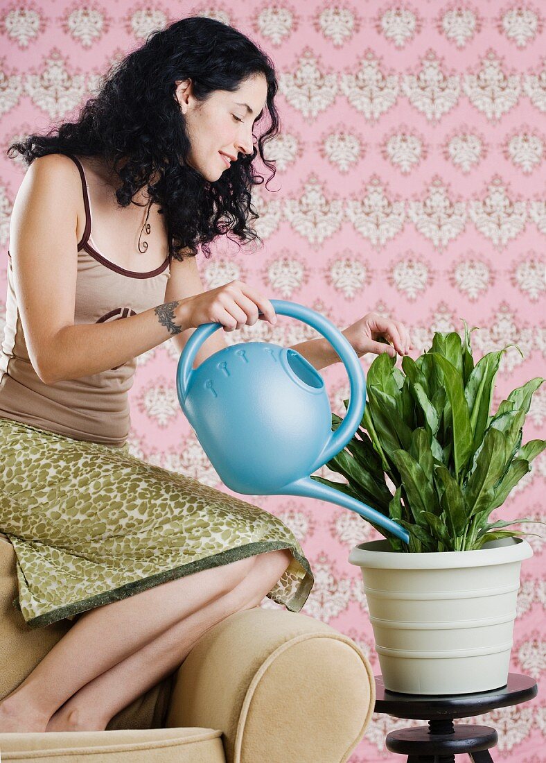 Young woman watering a plant