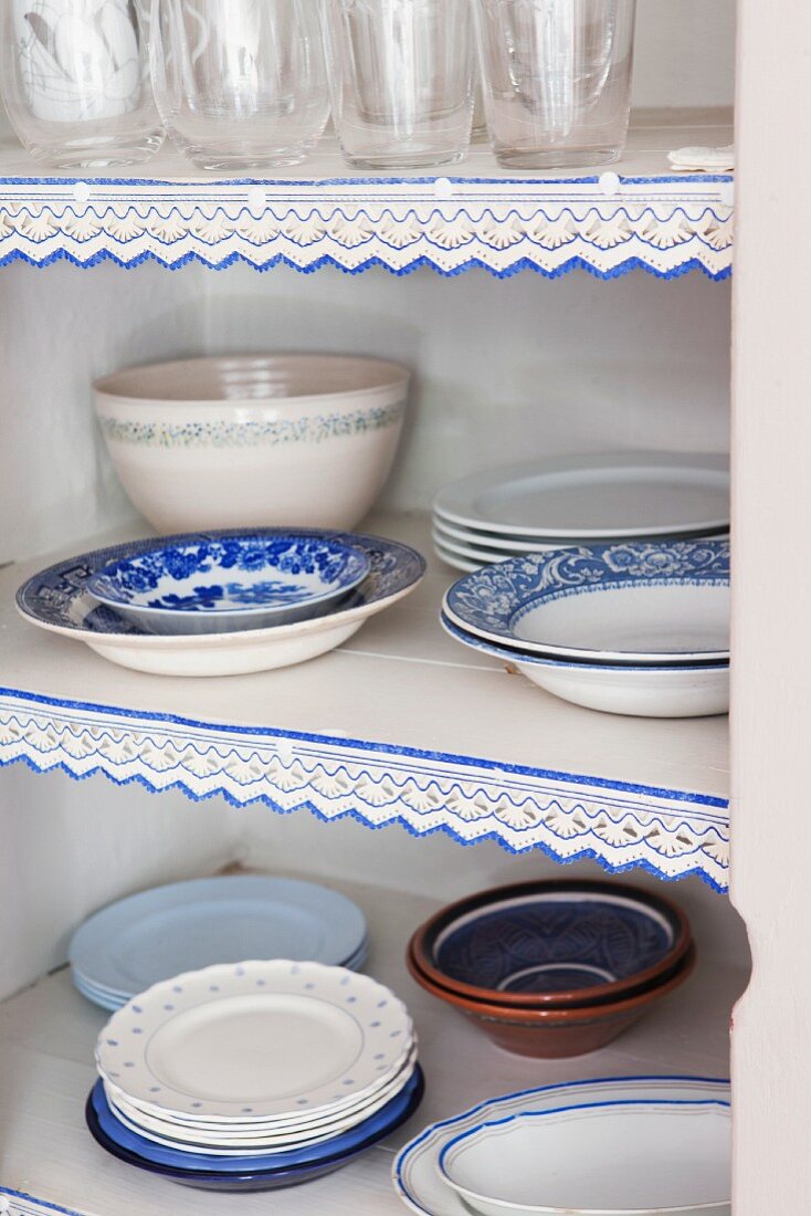 White and blue plates in cupboard