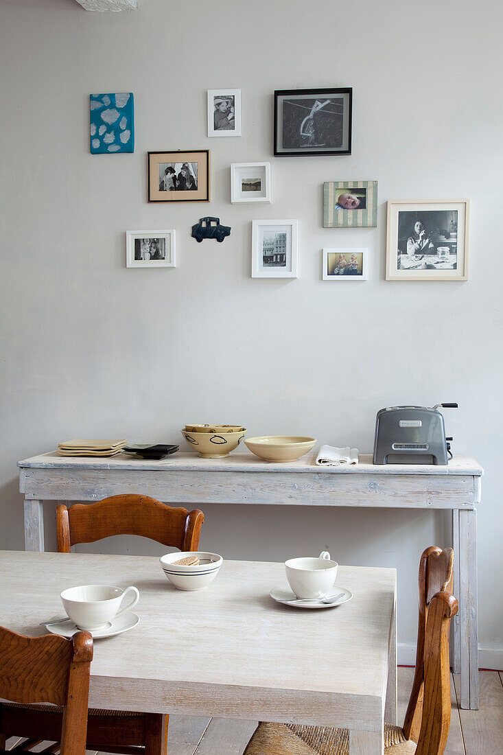 Dining area with wooden furniture and wall gallery of picture frames