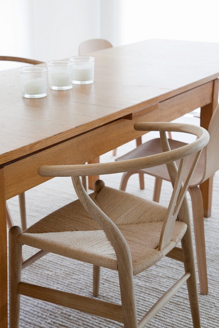 Langer Designer Holztisch mit Armlehnstuhl im skandinavischen Stil