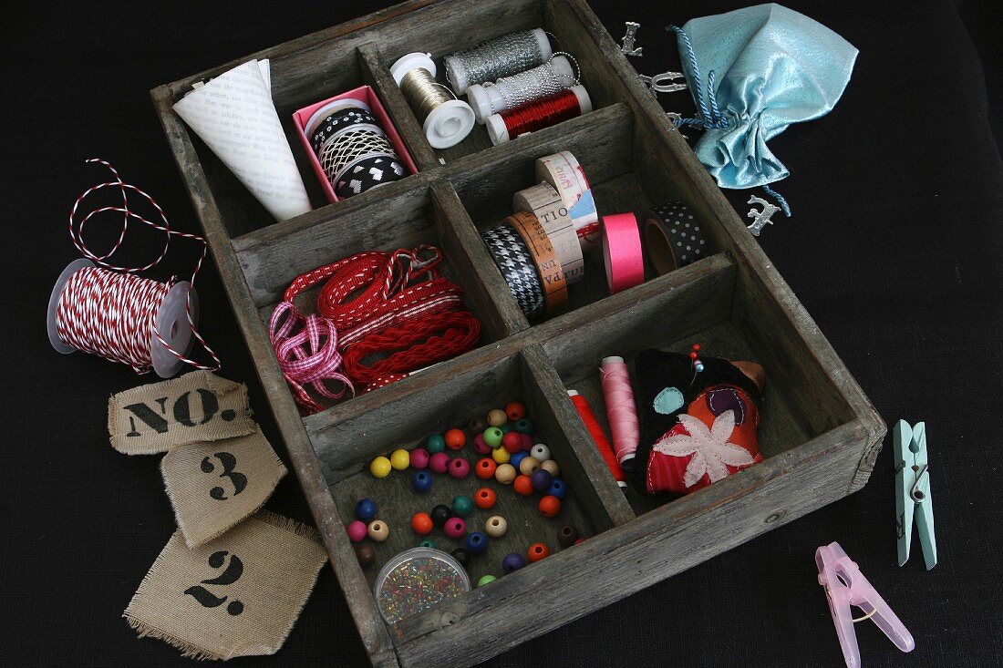 Craft, decoration and sewing utensils in vintage wooden case