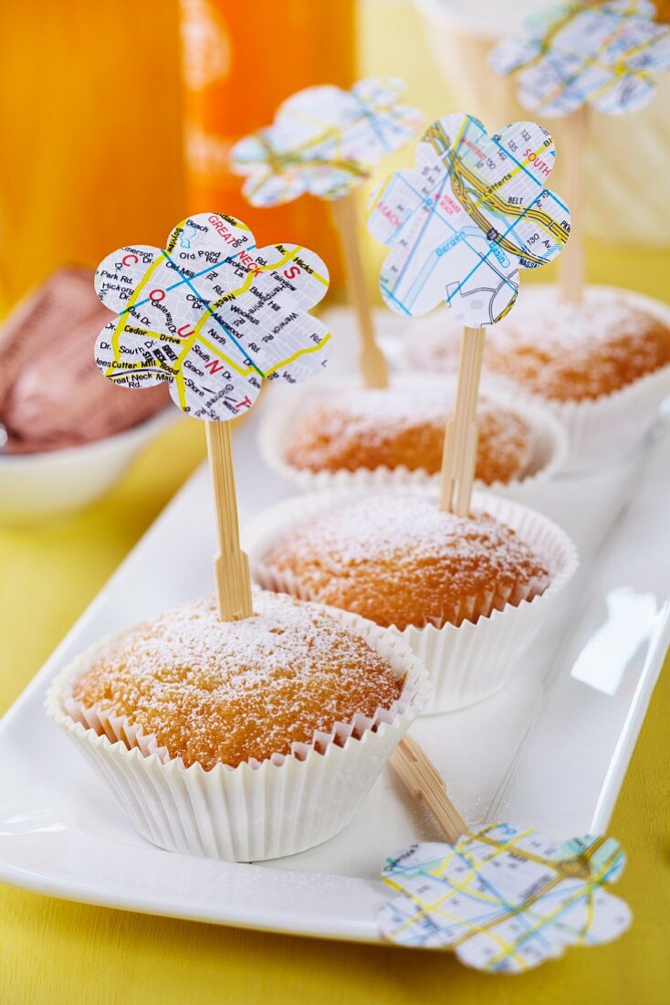 Lemon muffins with wooden skewers decorated with flower shapes punched out of map