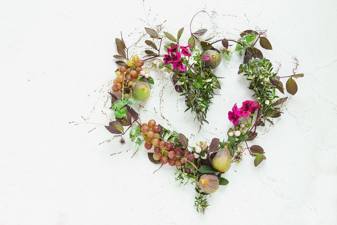 Heart made from autumnal flowers, leaves & fruits