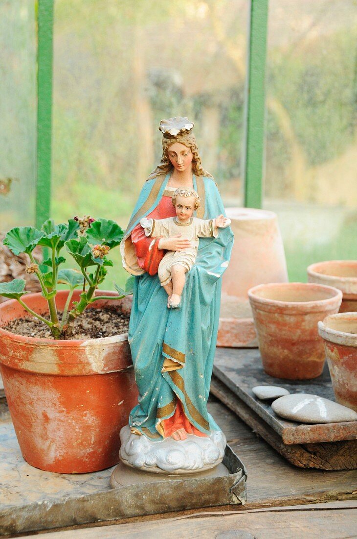 Madonna figurine in greenhouse