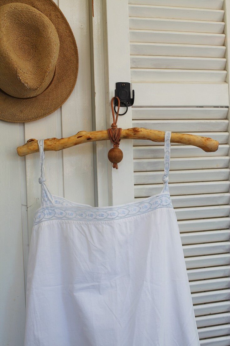 Vintage undershirt on rustic coathanger made from stripped, oiled branch with leather strap