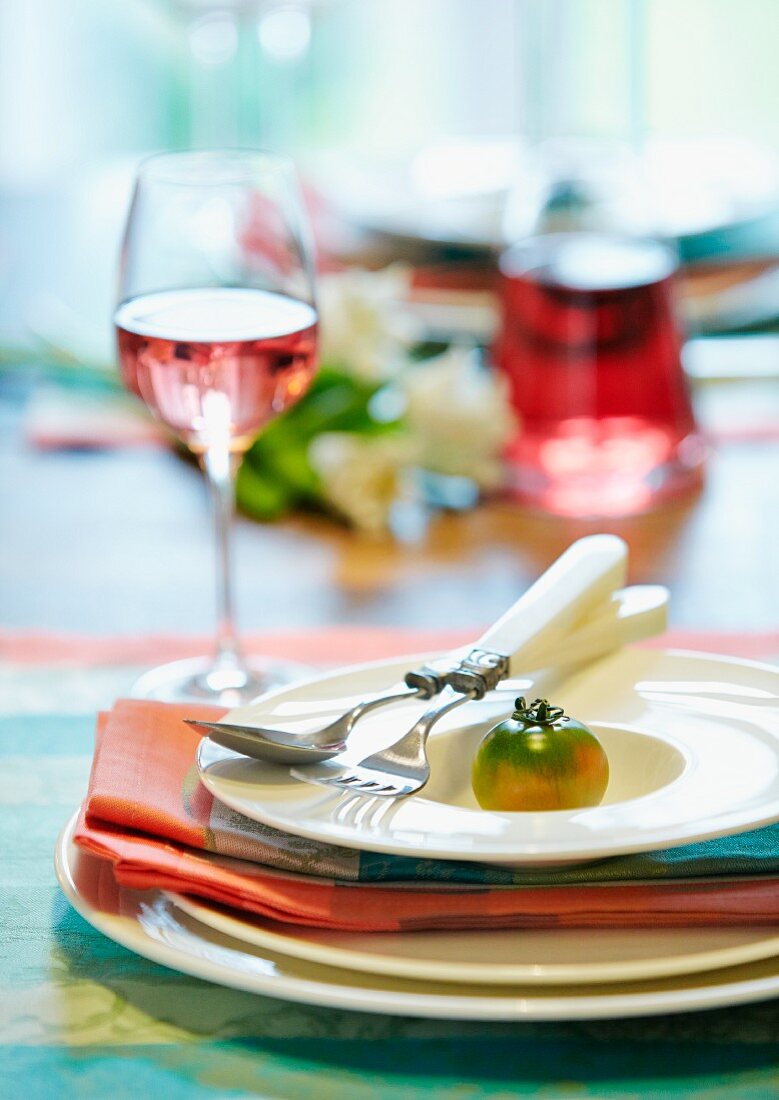 Place setting decorated with green tomato