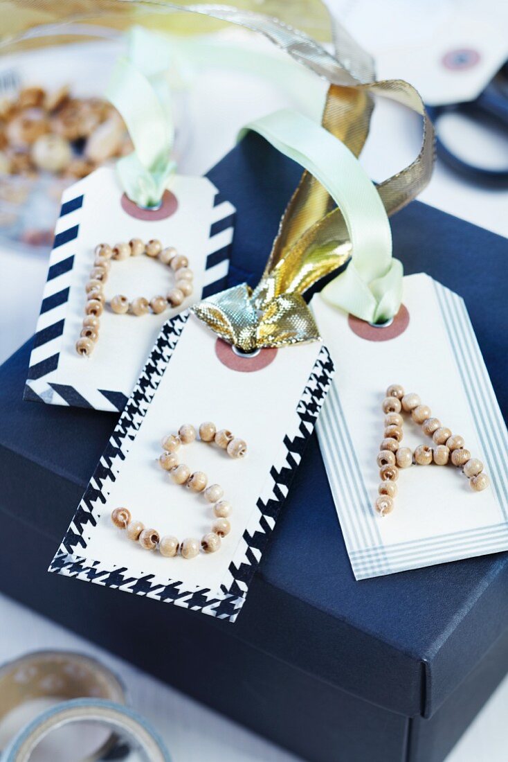 Gift tags with initials made from wooden beads