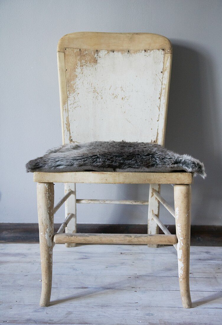 Old chair with fur seat cushion
