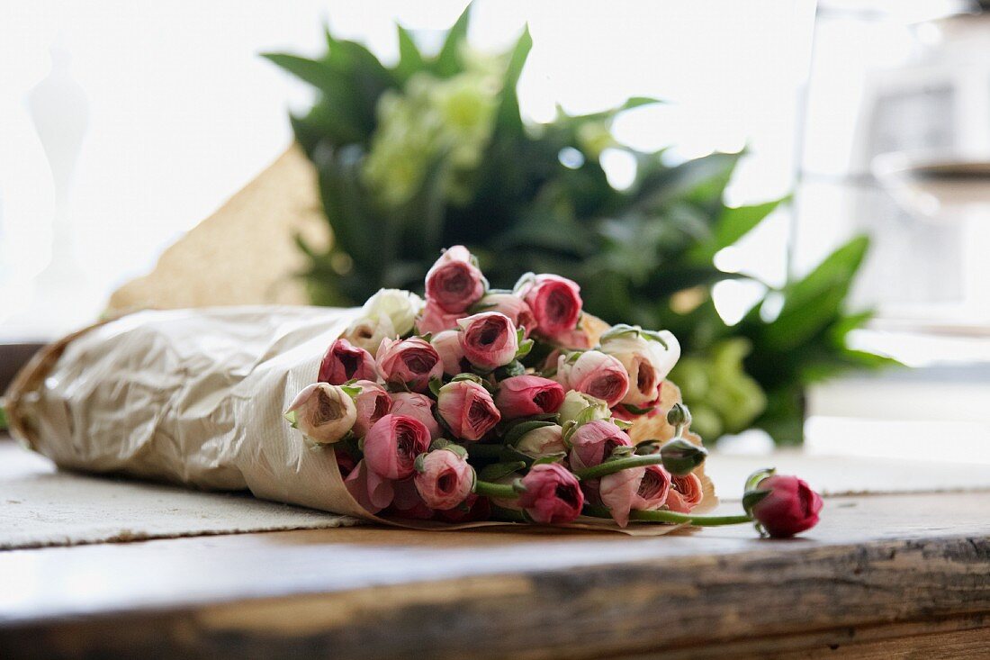 Bouquet of ranunculus wrapped in paper