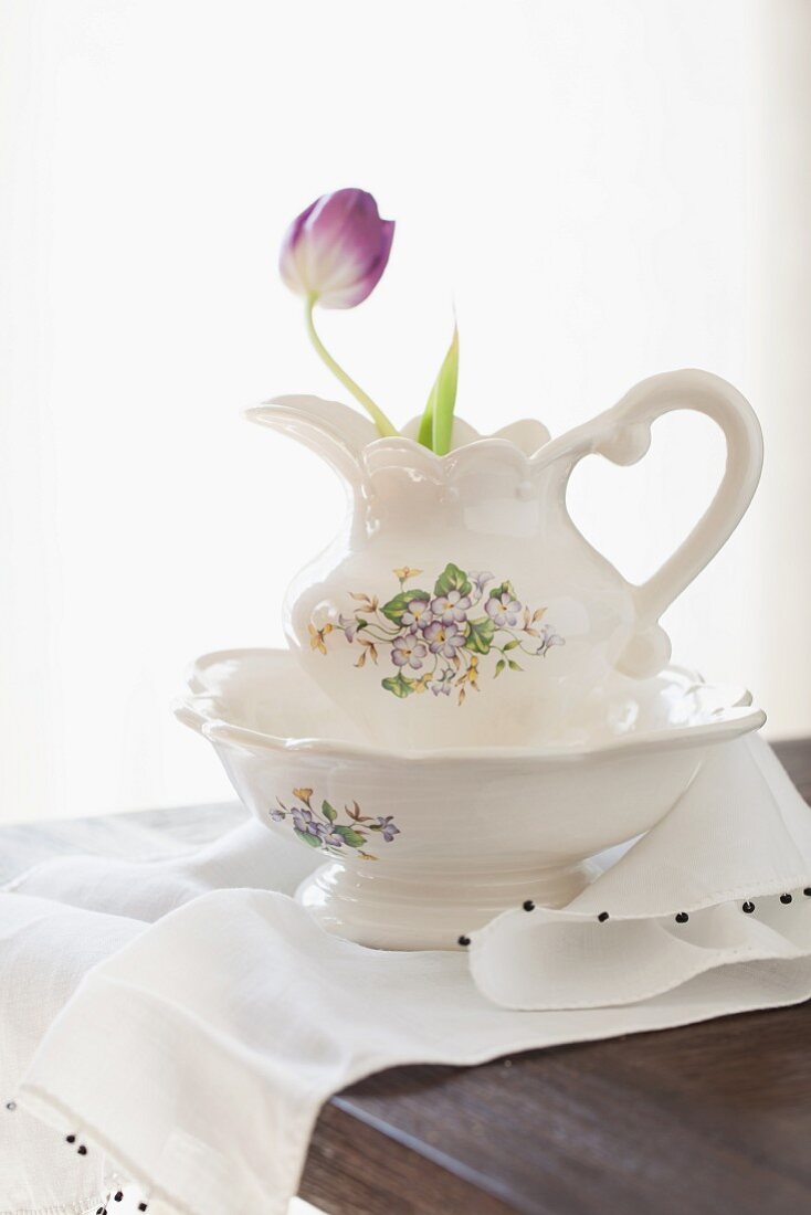 Purple tulip in ceramic pitcher and bowl set