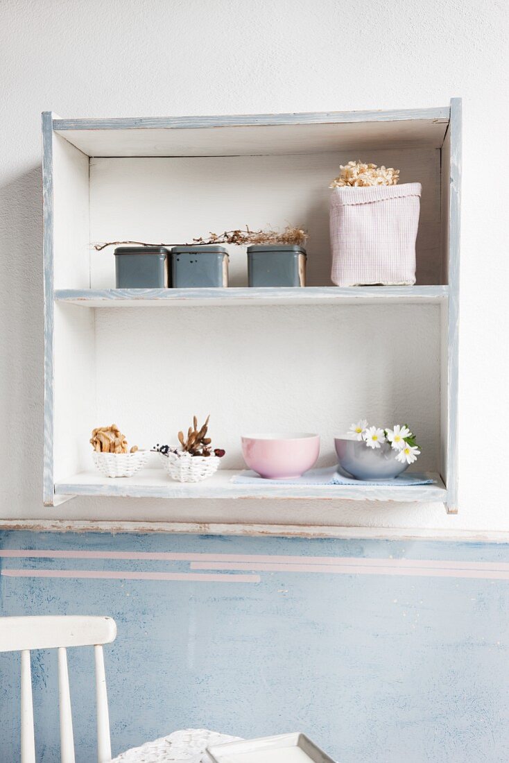 Upcycling - ornaments in painted, shabby-chic shelves on wall in vintage interior