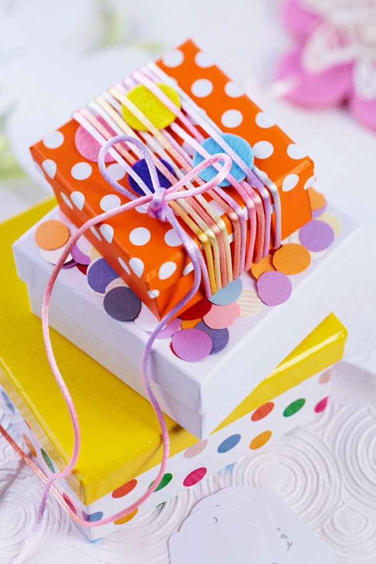 Gift boxes decorated with silk cord and confetti