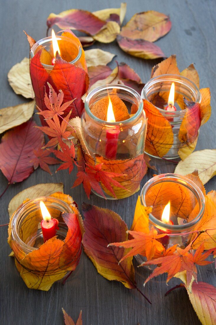 Candle lanterns decorated with autumn leaves