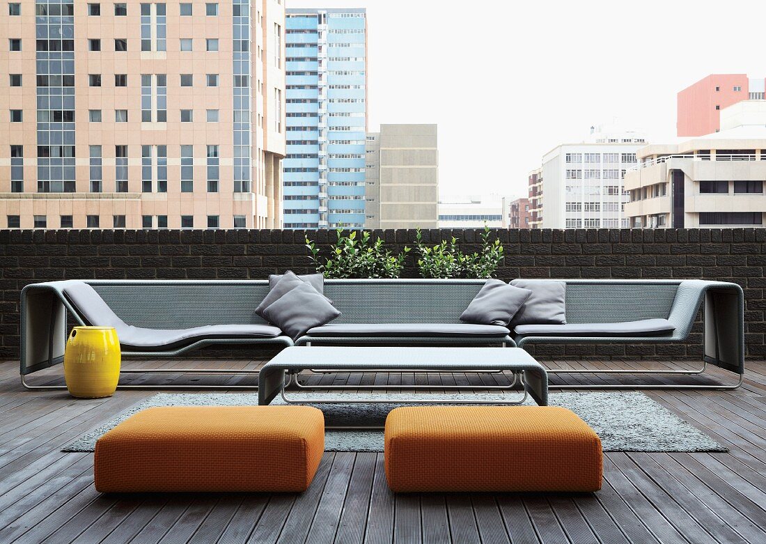 Inviting group of designer seating on loft-apartment terrace with view of cityscape in Johannesburg, South Africa