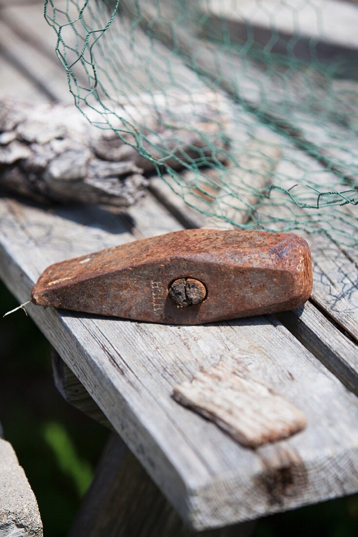 Rusty hammer on rustic wooden table