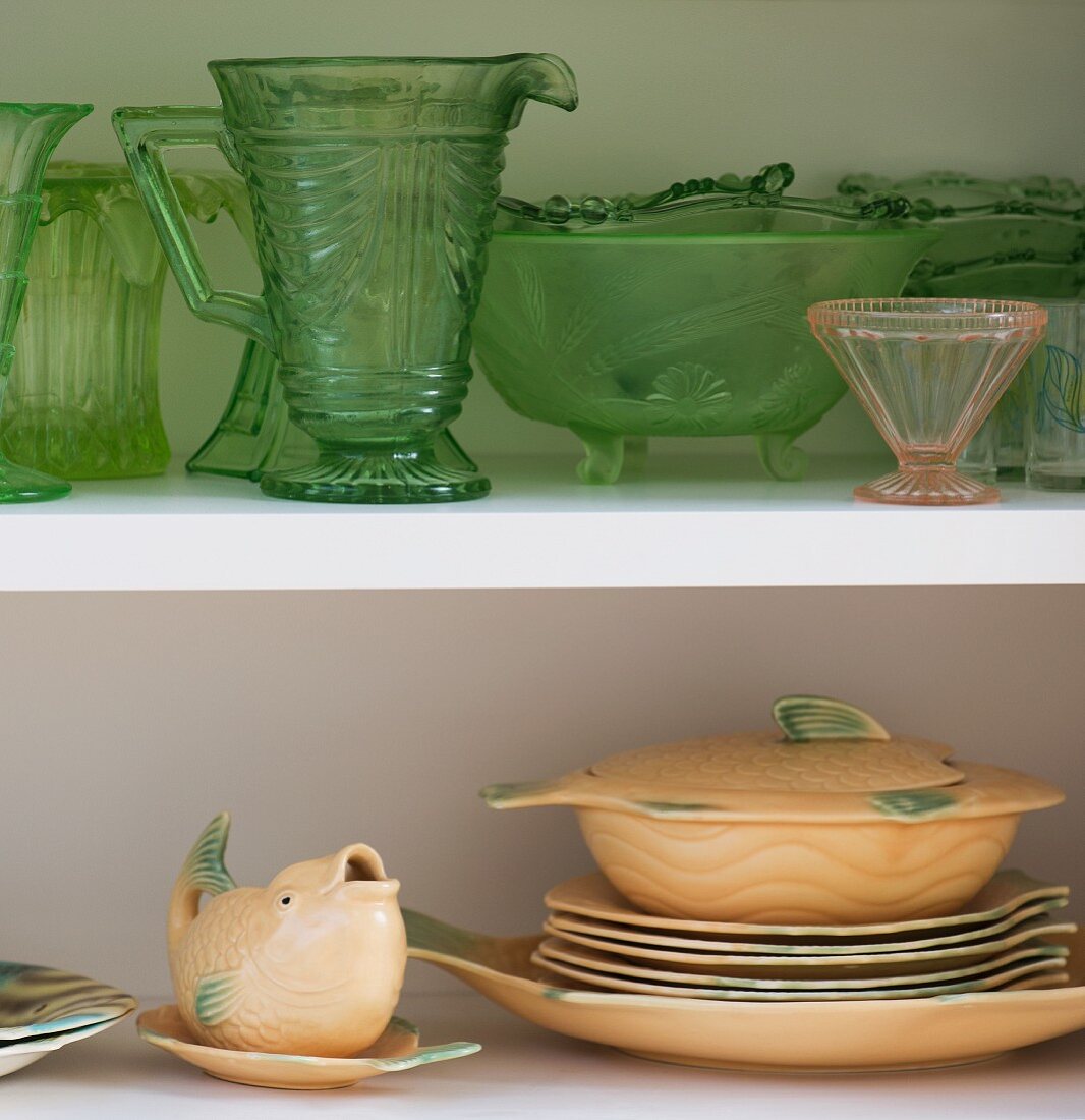 Vintage china crockery and glassware on open-fronted shelves